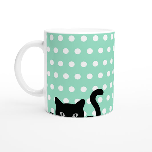 Taza con diseño de hermosos gatitos asomándose a cada lado de la taza, sobre un fondo verde de lunares