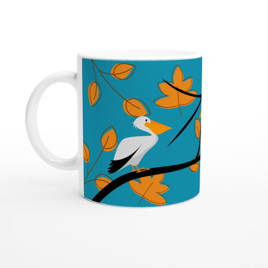 Taza de cerámica con diseño de pelícanos posados sobre ramas. Colores azul y naranja.